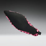 A single pointed-toe shoe shown floating against a dark-to-light gray gradient background. The upper is black with a pink and black spotted pattern around the edges and heel.