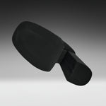 A black molded plastic component, likely a footrest or ergonomic support pad, shown floating against a dark-to-light gray gradient studio background.