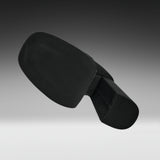 A black molded plastic component, likely a footrest or ergonomic support pad, shown floating against a dark-to-light gray gradient studio background.