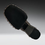 A black fabric-covered shoe sole with a decorative scalloped metallic edge and a gray footbed, shown on a gradient gray background.
