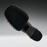 A black fabric-covered shoe sole with a decorative scalloped metallic edge and a gray footbed, shown on a gradient gray background.