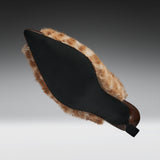 A black pointed-toe shoe with a brown and beige faux-fur trim, shown from a side angle against a dark gray gradient background.