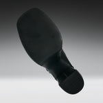 A black shoe sole shown floating against a gradient gray background.