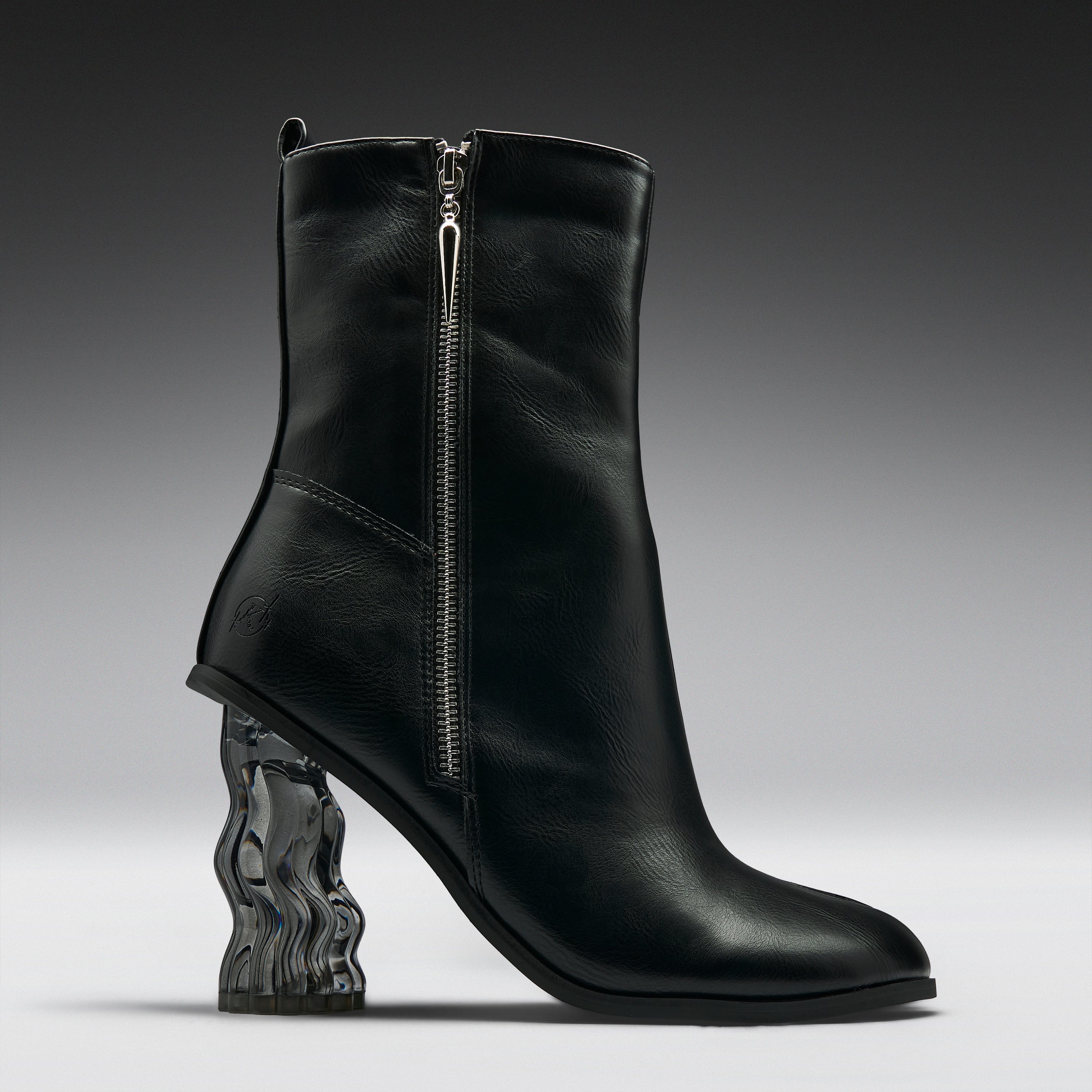 A black leather ankle boot with a sculptural, wavy transparent block heel, shown from a side profile against a dark gray studio background.