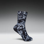 A single crew sock with a black and white comic book panel print, shown in a floating pose against a dark gray gradient background.
