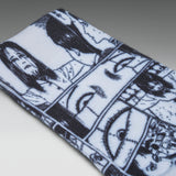 A close-up of a white knit fabric item, likely a sock or cuff, featuring a black and white comic-style illustration of faces and eyes.