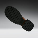 A close-up of a black rubber boot sole with deep grooves and a brown heel, shown against a dark-to-light gray gradient background.