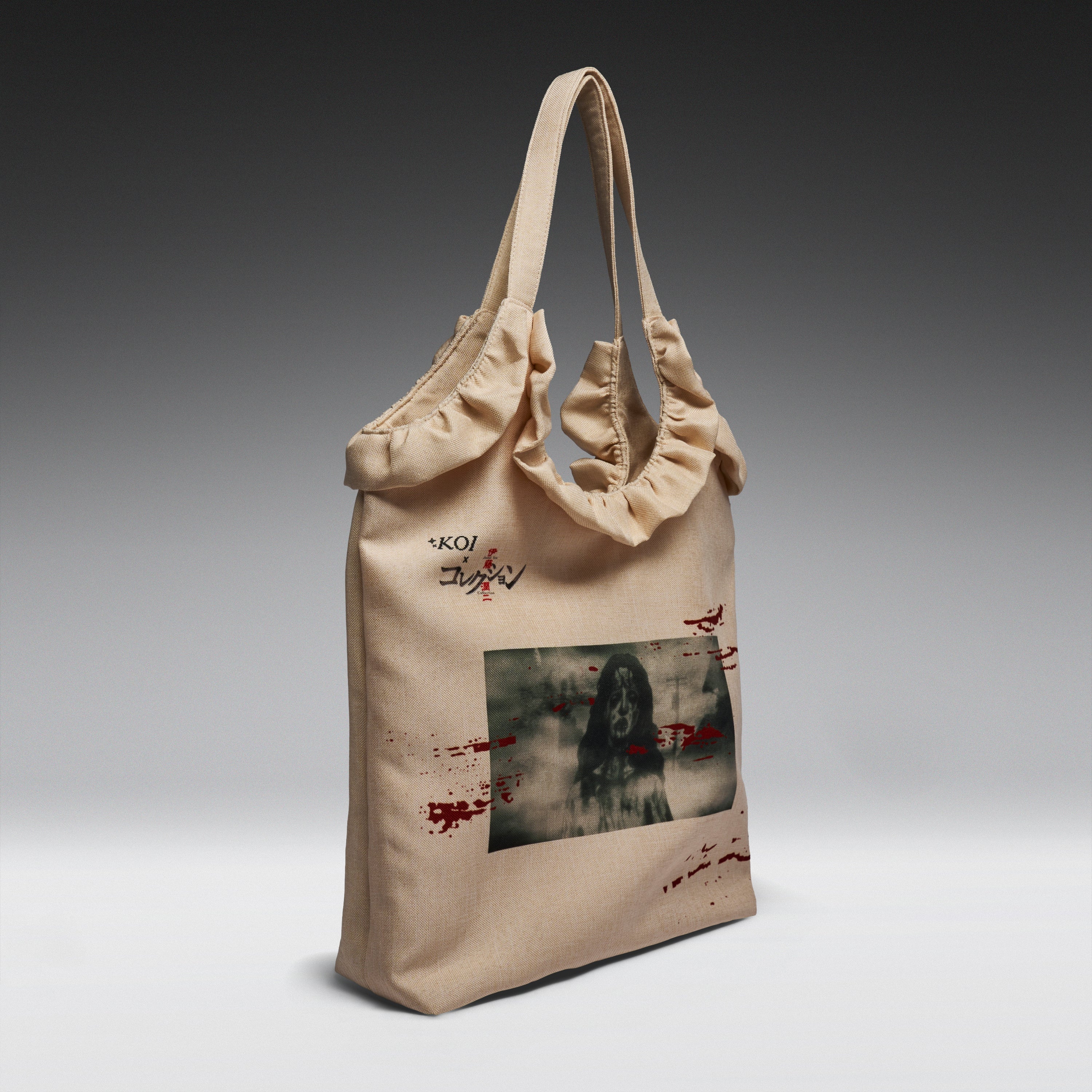 A beige canvas tote bag with ruffled trim and dual shoulder straps, featuring a horror-themed graphic print with a dark figure and red splatter details, and the text 'KOI' on the front, shown against a dark-to-light gray gradient background.