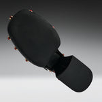Black martial arts kicking pad with a textured head and a padded striking surface, shown floating against a dark gray gradient background.