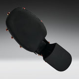 Black martial arts kicking pad with a textured head and a padded striking surface, shown floating against a dark gray gradient background.