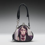 A heart-shaped black leather clutch purse featuring a printed anime character illustration on the front, complete with a black shoulder strap and kiss-lock clasp, set against a dark gray gradient background.