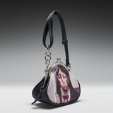 A black faux-leather coin purse featuring a printed anime illustration of a character with long dark hair and a red bow tie on the front flap. The purse has a silver-tone metal clasp, a black shoulder strap, and a hanging silver chain with a black tassel, photographed against a dark-to-light gray gradient studio background.