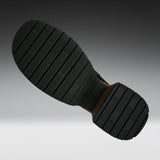 A close-up of a black rubber shoe sole with deep grooves, shown against a gradient gray background.