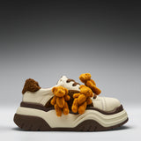 White sneaker with brown and beige teddy bear decorations on a gray background