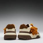 Pair of shoes with teddy bear design on a gray background