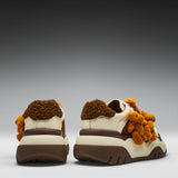 Pair of shoes with teddy bear design on a gray background