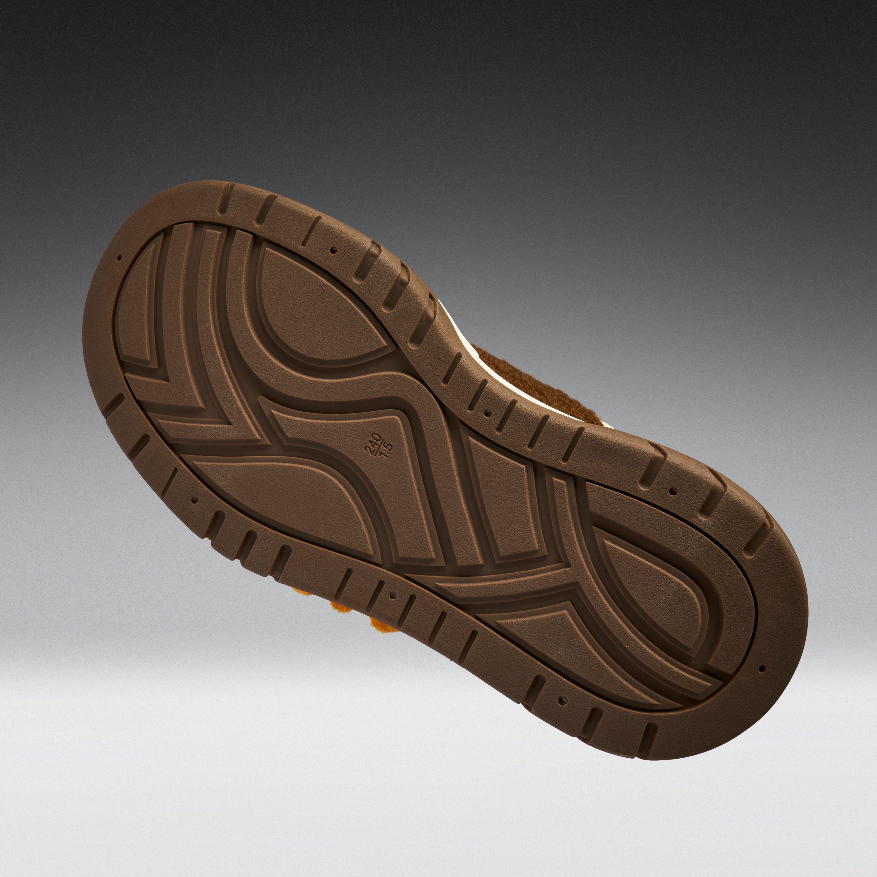 Brown shoe sole on a gradient gray background