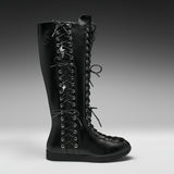 A single black leather knee-high lace-up boot with silver metal eyelets and decorative skull-and-crossbones laces, shown in profile against a dark gray studio background.