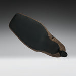A motorcycle or bicycle leather saddle with a black textured rubber seat pad and a brown leather body, shown floating against a gradient gray background.