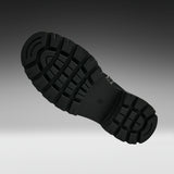 A close-up of a black rubber shoe sole with deep tread patterns, shown floating against a dark-to-light gray gradient background.