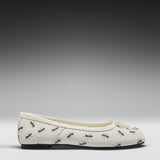 A single cream-colored ballet flat shoe with a repeating pattern of black and brown ants, shown in profile against a dark-to-light gray gradient studio background.