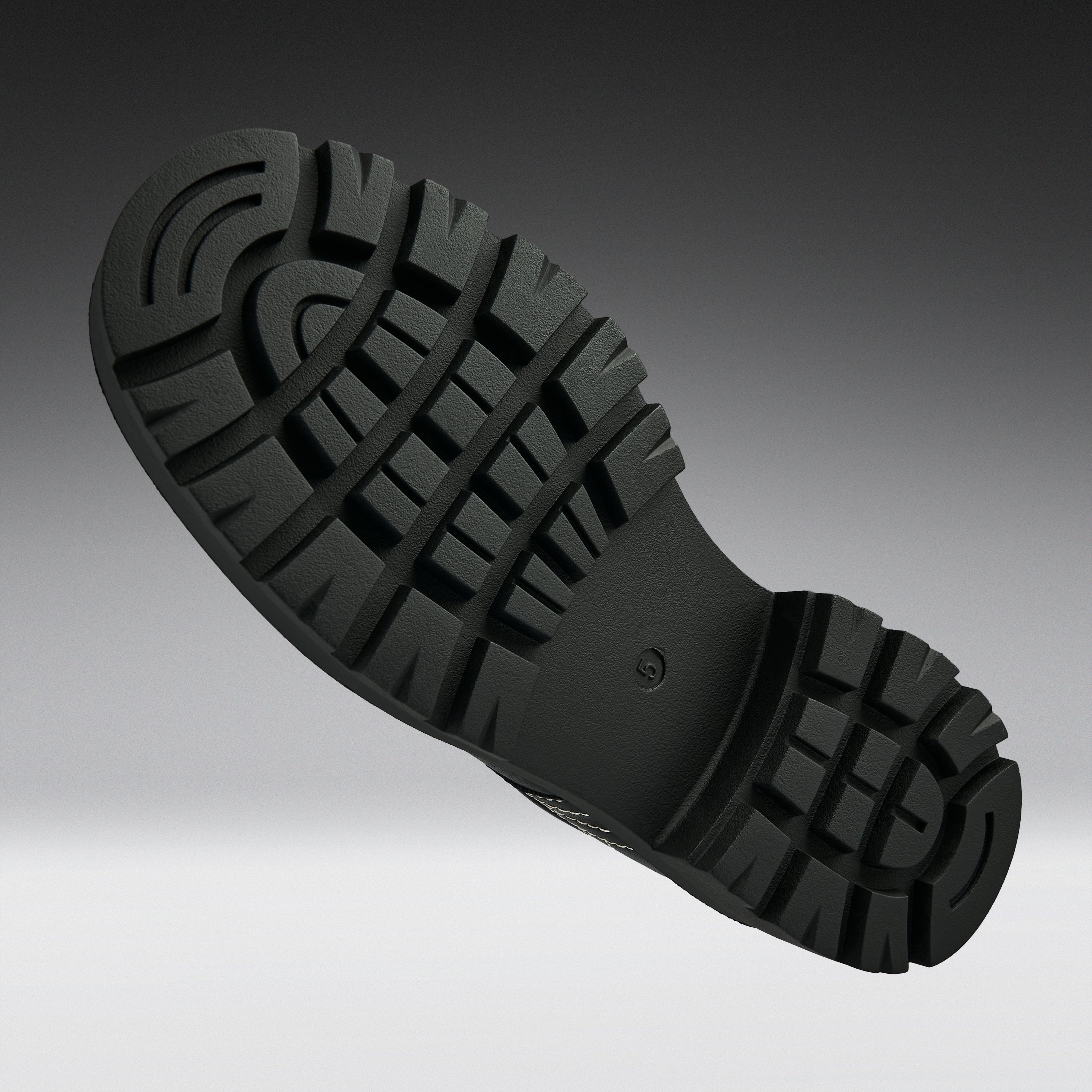 A close-up of a black rubber shoe sole with deep lugs and a textured tread pattern, shown against a dark-to-light gray gradient background.