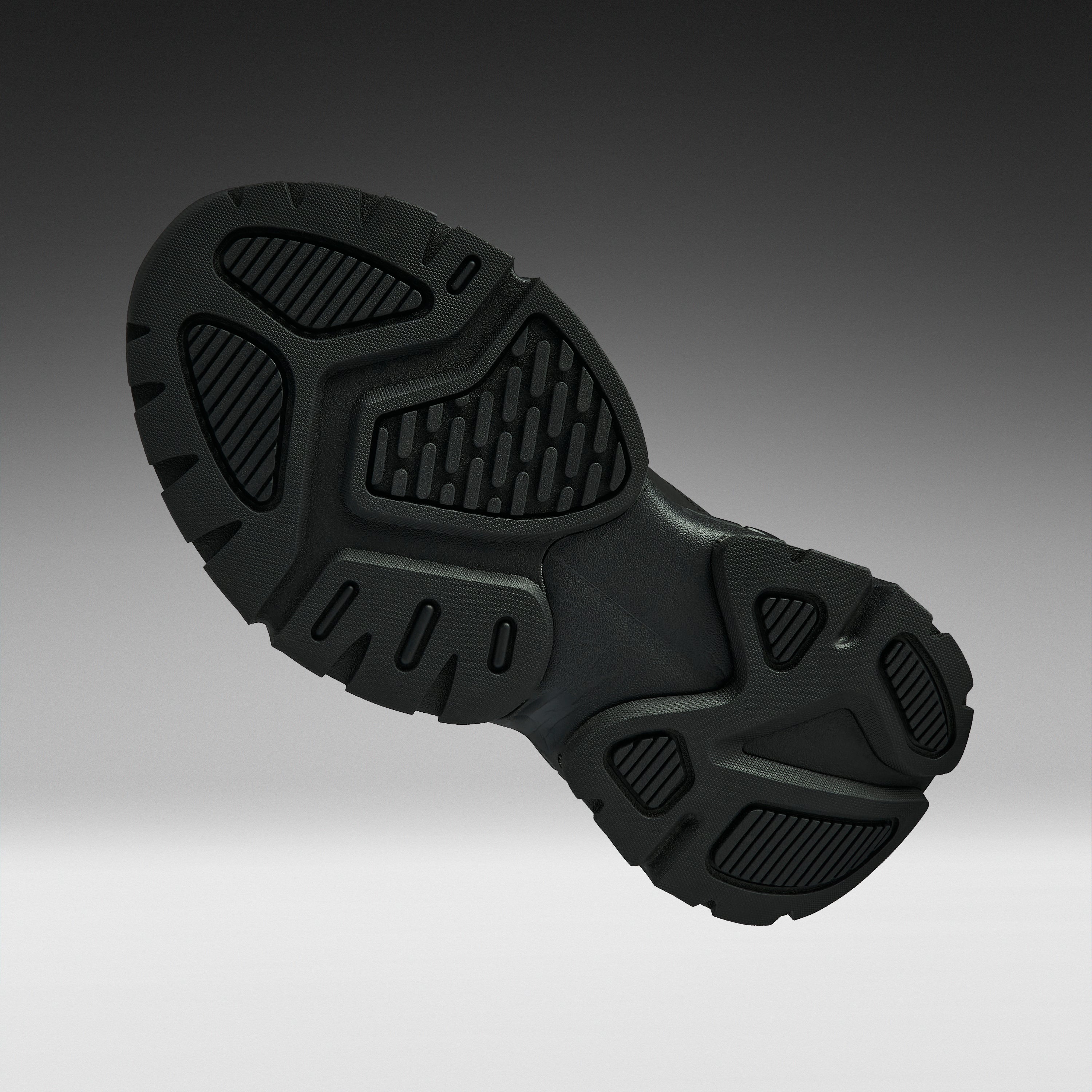 A close-up of a black athletic shoe's textured outsole, shown from a side angle against a dark-to-light gray gradient background.
