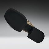 A black motorcycle or bicycle handlebar grip cover with a textured black rubber face and a camouflage-patterned stem section, shown against a dark gray gradient background.