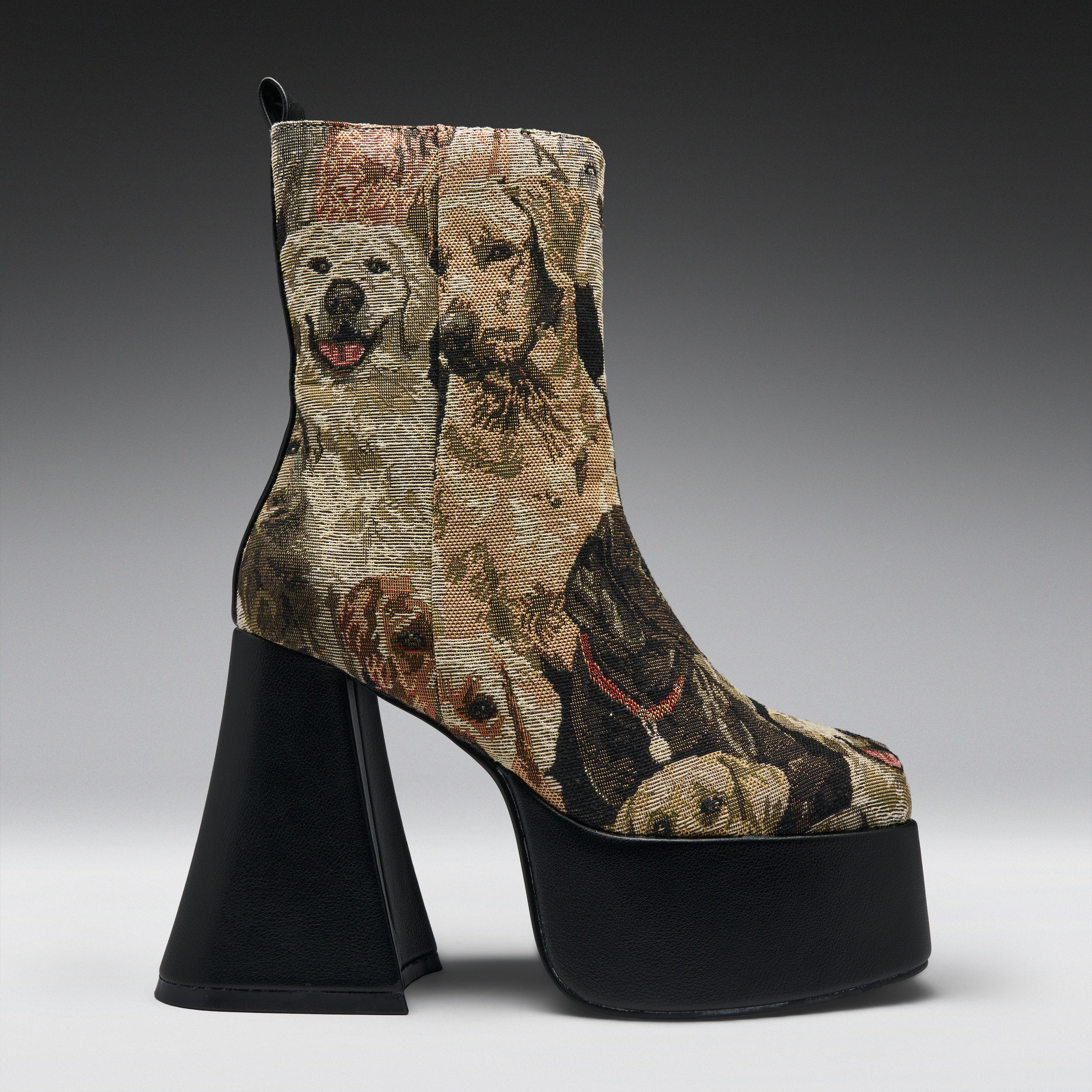A high-heeled ankle boot with a black platform sole and block heel, featuring a woven or printed pattern of various dog portraits in beige, brown, and black tones.