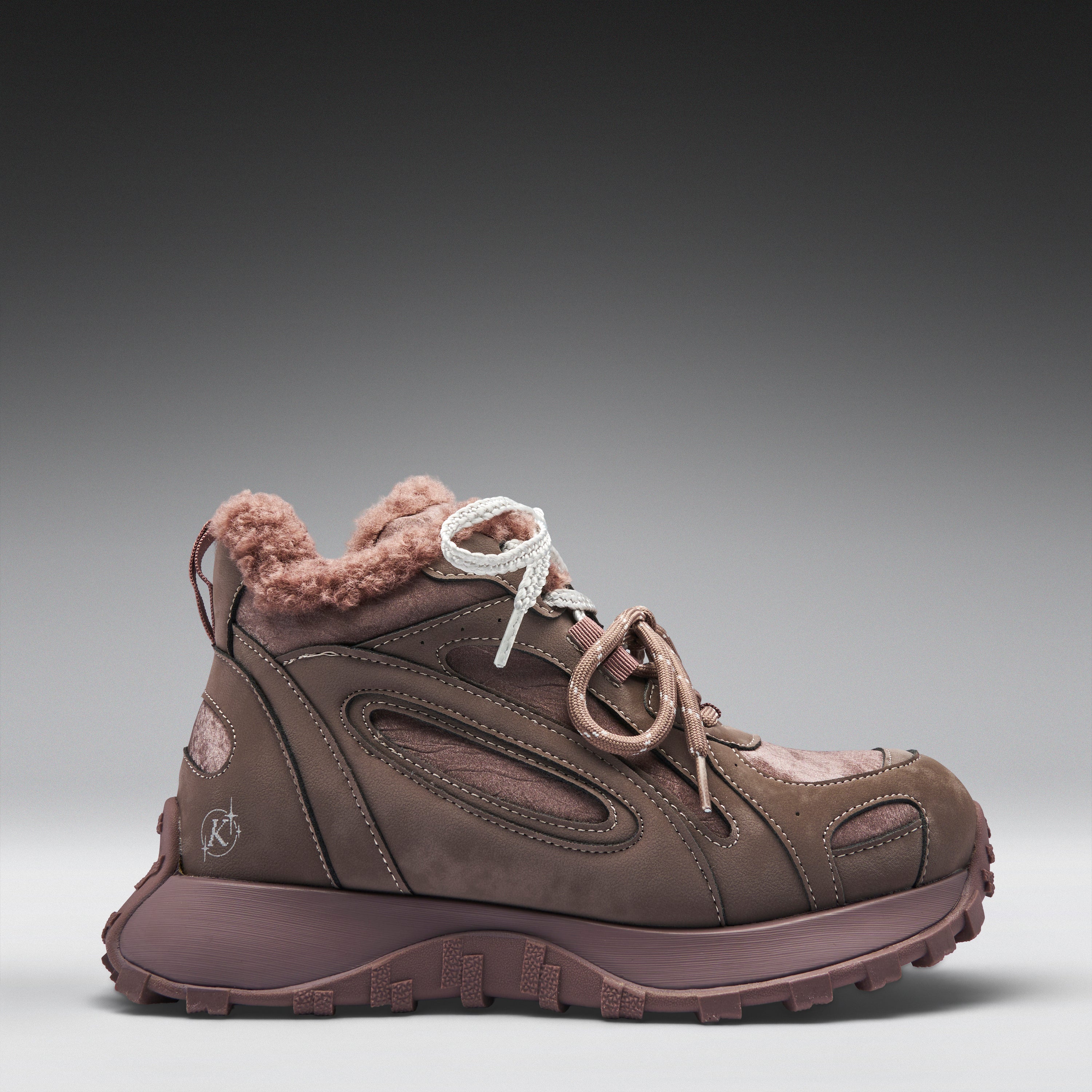 Brown winter boot with fur lining on a gray background