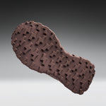 Brown shoe sole with tread pattern on a gray background